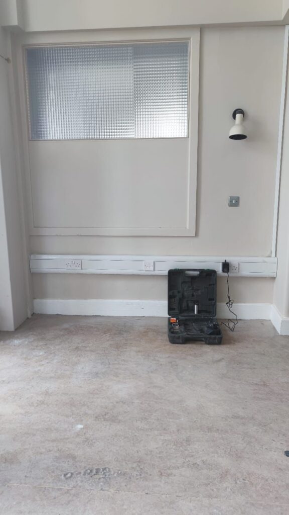 a black tool box on a white floor